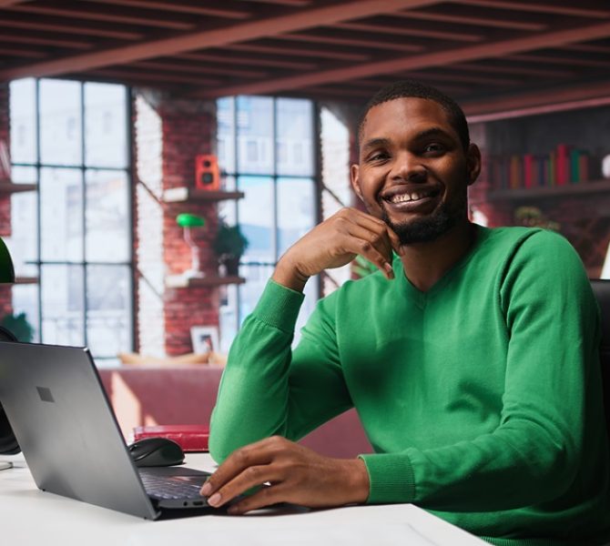 African american remote worker solving his daily freelancing tasks on laptop African american remote worker solving his daily freelancing tasks on laptop